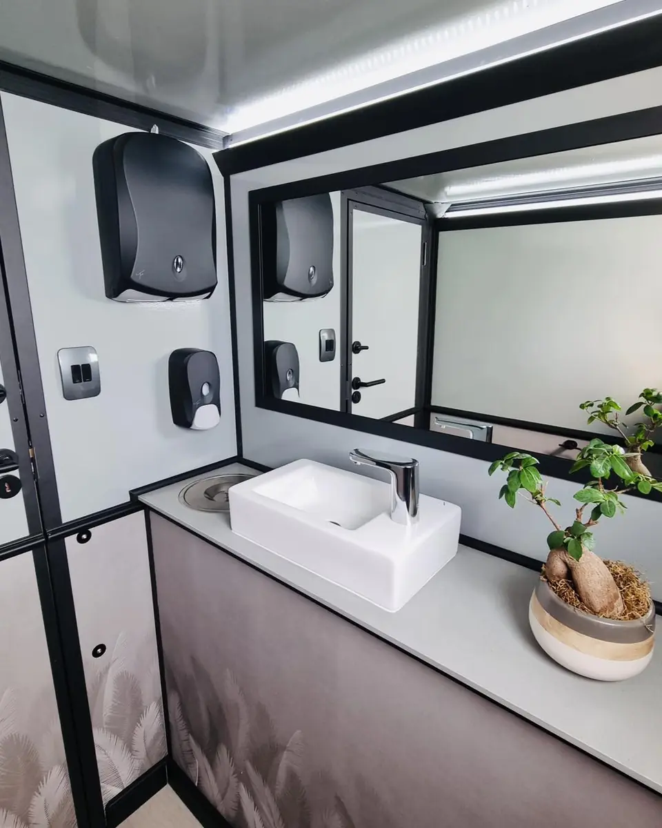 Restroom trailer sink, mirror, paper towel and soap dispensers